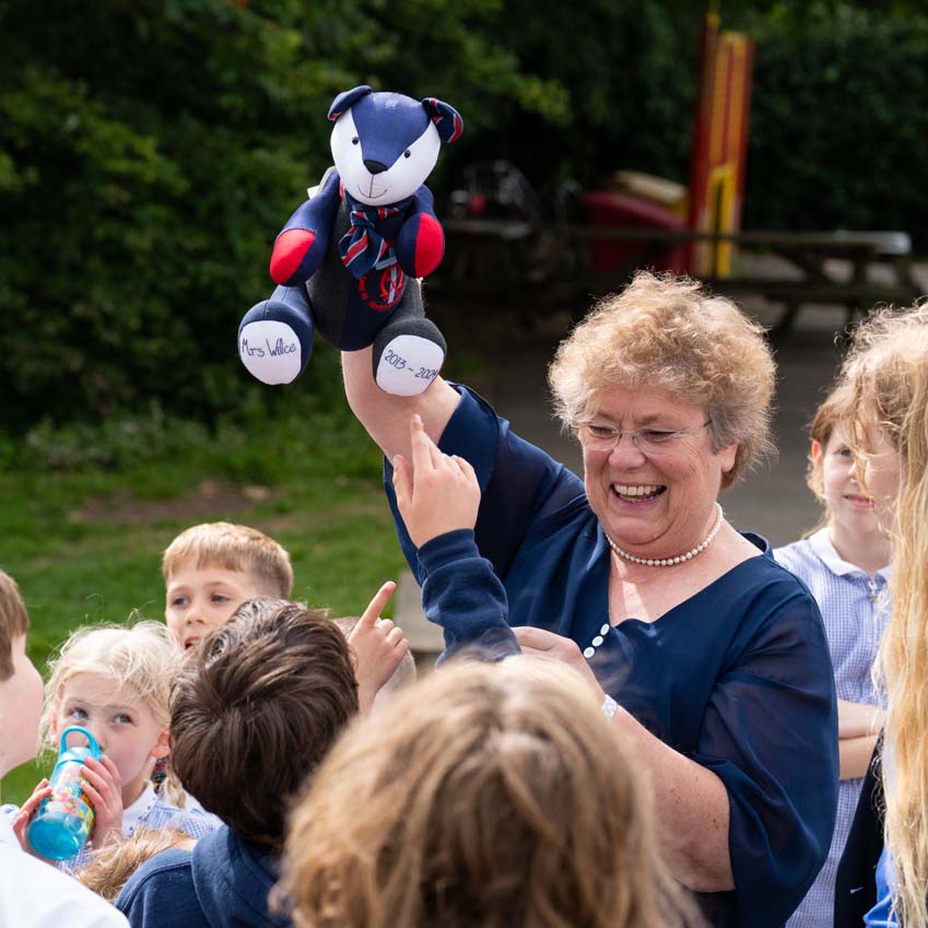 Mrs Wilce SMSJ leaving present school uniform bear