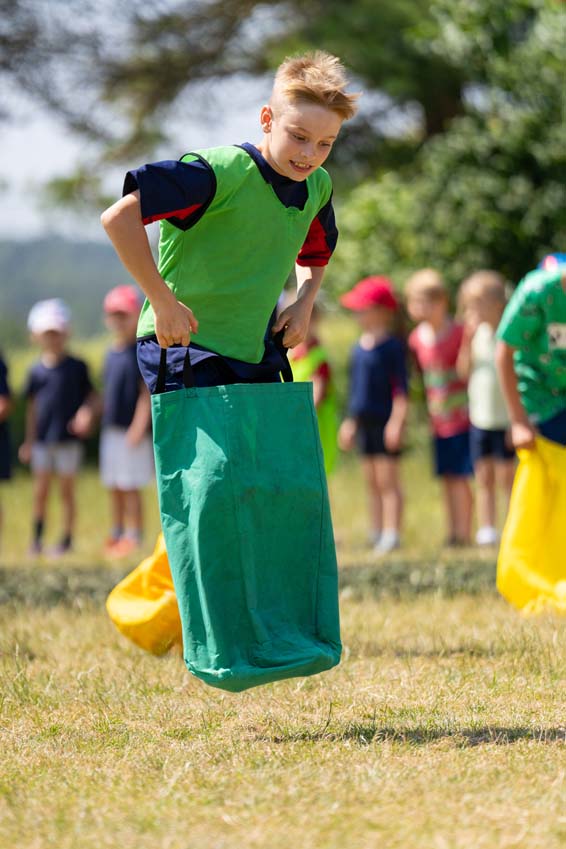 SMSJ North Luffenham primary school sports day sack race boy jumping hopping high