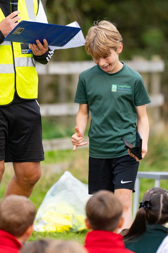 Leighfield Uppingham primary school boy celebrates winning an award at the Rutland cross country championships