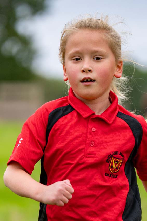Brook Hill primary school girl running confidently at the Rutland cross country championships