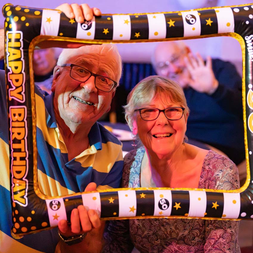 Having a laugh at a surprise 50th birthday party with this fun photo frame