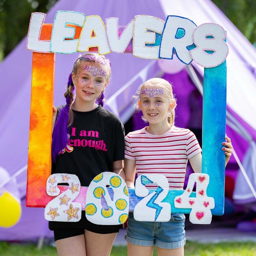 Girls having their photo taken in their leavers party fun photo frame