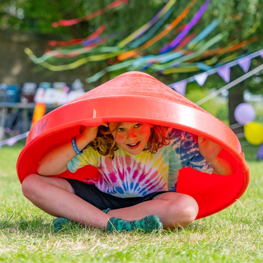 Primary school boy hiding under a cone at the leavers party