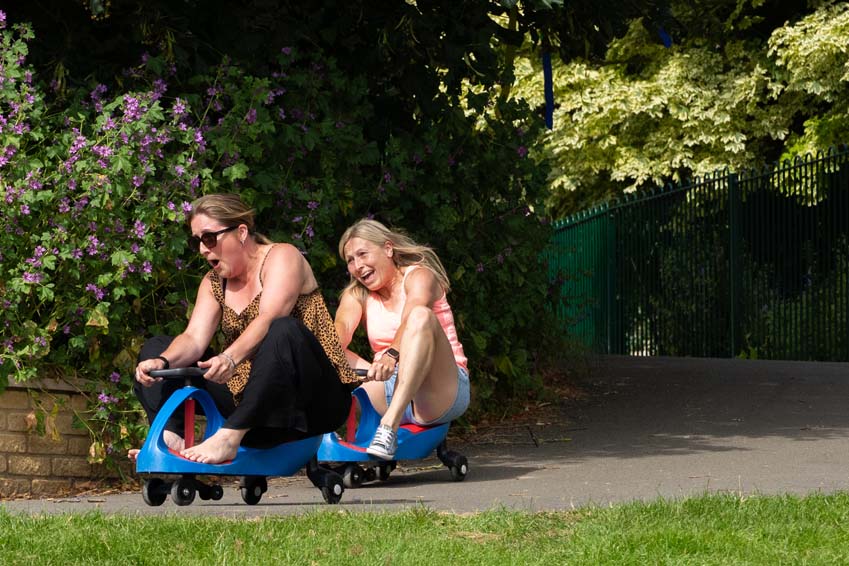 Primary school parents having fun at leavers party on the crazy carts