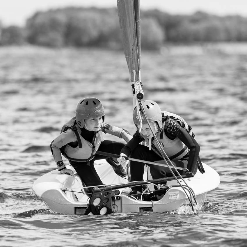 Primary school boys concentrating on tacking at the Rutland Water Sailing Club