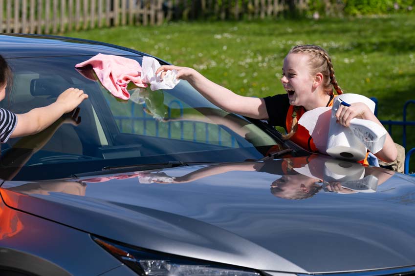 SMSJ Primary School hand car wash fundraiser girls polishing laughter