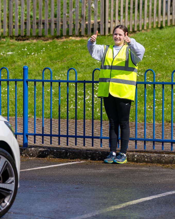 SMSJ Primary School hand car wash fundraiser directing traffic thumbs up