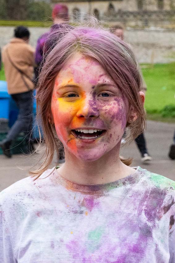 Hindi Holi festival of colour being celebrated with this primary school girl covered in powder