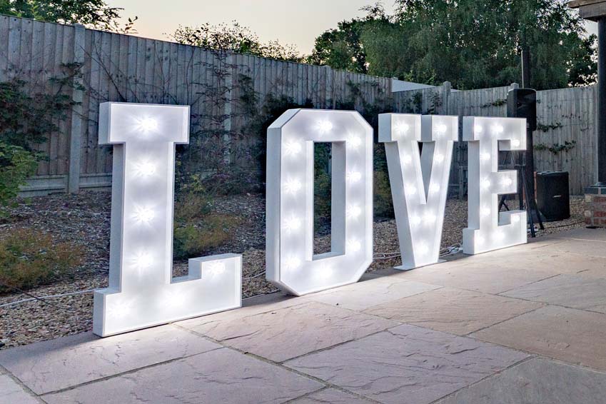 Picks Barn Lyndon wedding light up love prop on the side of the outdoor daning area