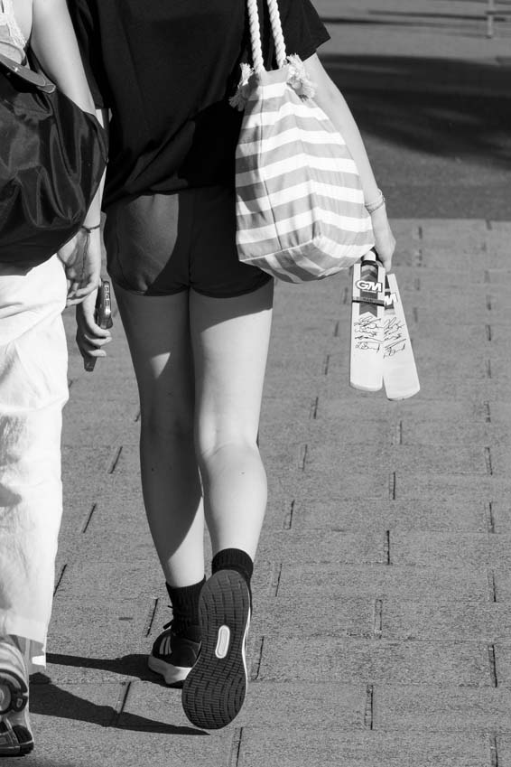 Girls walking home carrying signature mini bats after a day watching England Women's cricket team at Trent Bridge