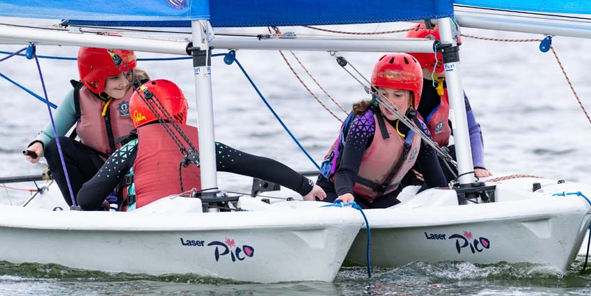 Determined funny face as sailing boats collide at Rutland Water primary school day